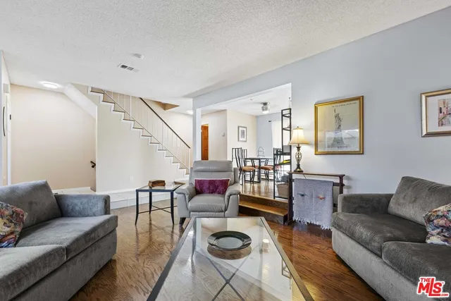 a living room with furniture a rug and a table