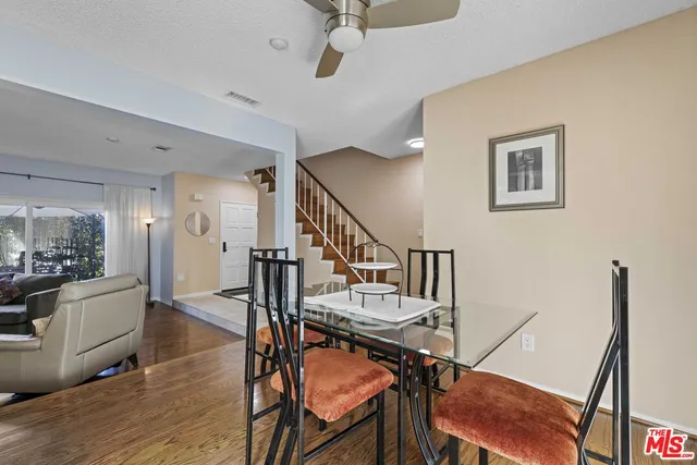 a view of a livingroom with furniture a fireplace a chandelier fan and wooden floor