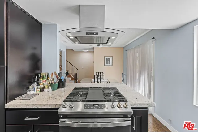 a view of a kitchen counter space a stove and wooden floor