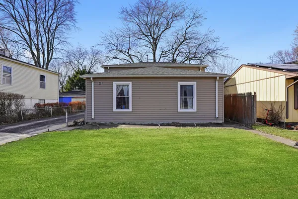 a backyard of a house with table and chairs