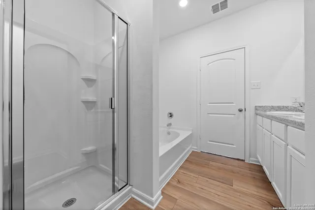 a bathroom with a bathtub and a shower