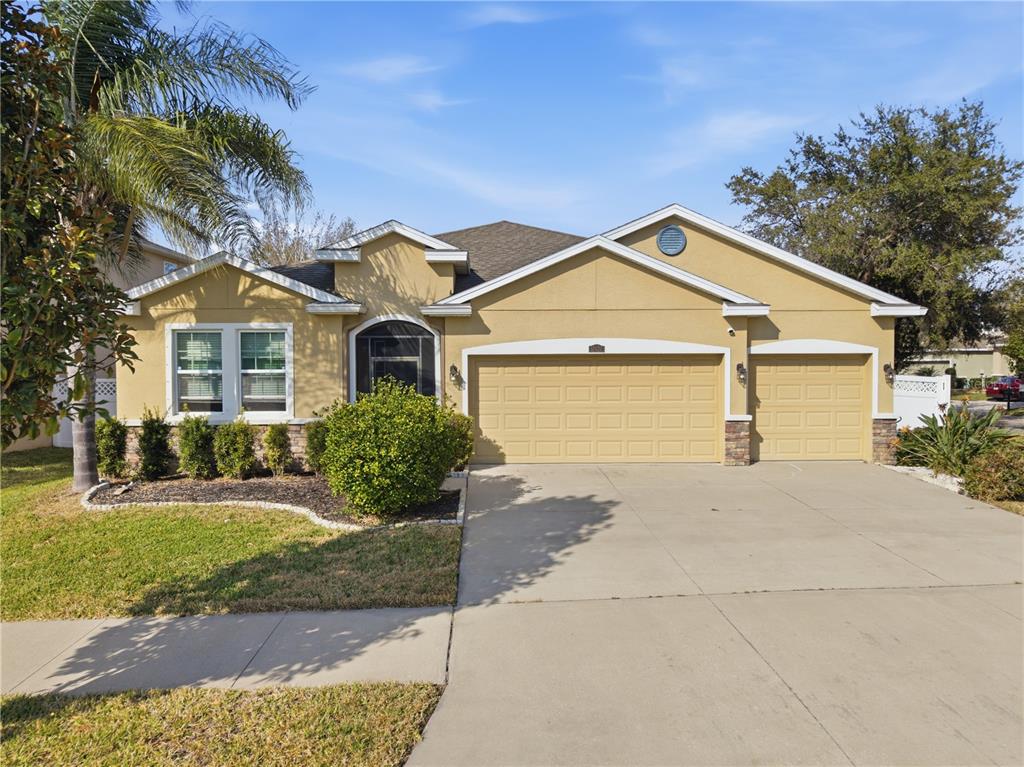 10420 Pleasant Spring Way Riverview, FL 33578 - Photo 3 of 32 a front view of a house with a yard and potted plants