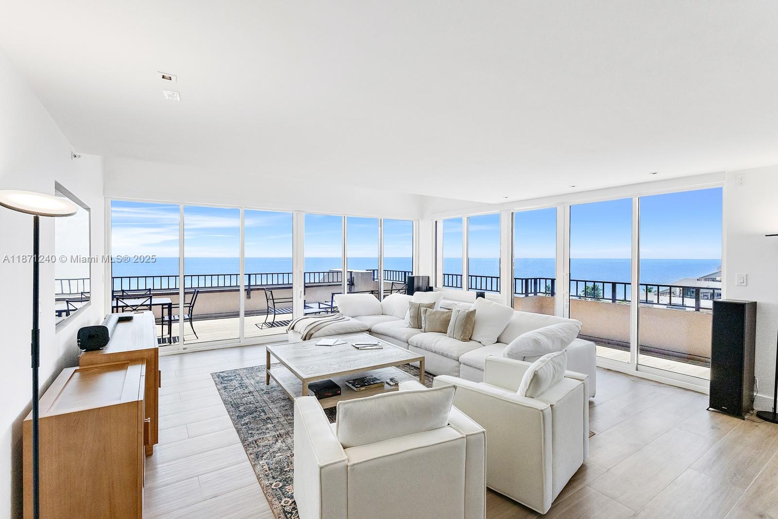 251 Crandon Boulevard, Unit 1036 Key Biscayne, FL 33149 - Photo 1 of 38 a living room with furniture and a table