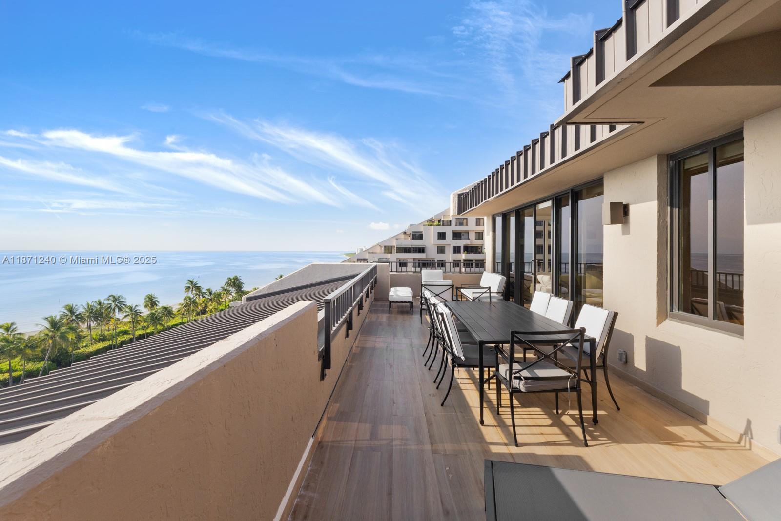 251 Crandon Boulevard, Unit 1036 Key Biscayne, FL 33149 - Photo 13 of 38 a view of a chairs and table on the terrace