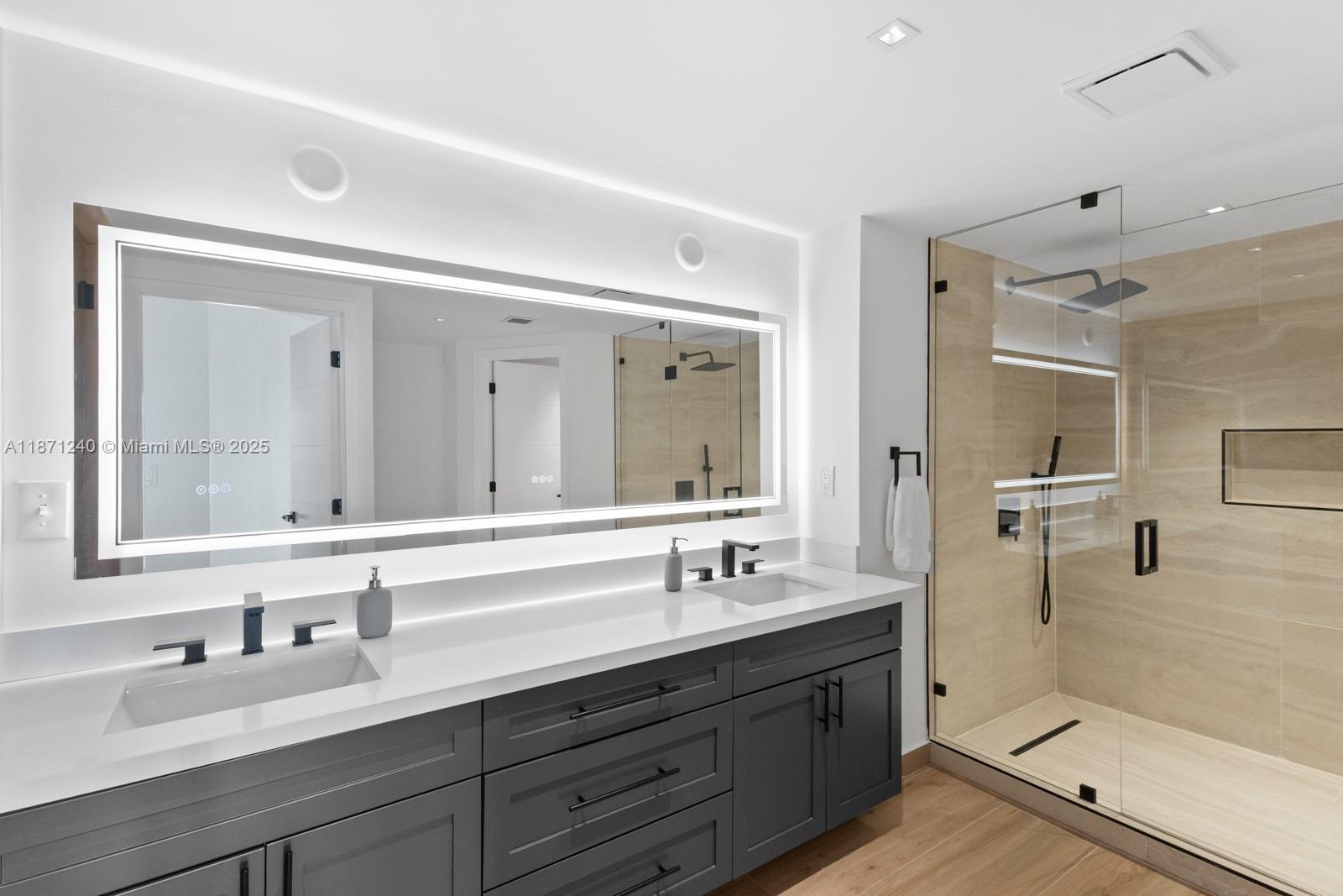 251 Crandon Boulevard, Unit 1036 Key Biscayne, FL 33149 - Photo 14 of 38 a bathroom with double vanity sinks and a mirror