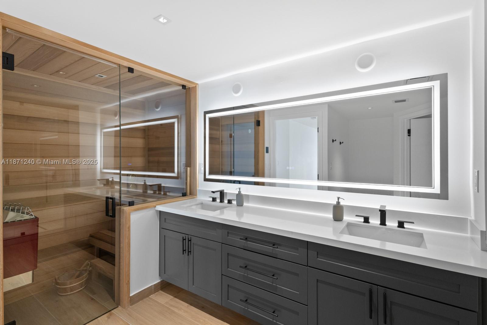 251 Crandon Boulevard, Unit 1036 Key Biscayne, FL 33149 - Photo 15 of 38 a bathroom with a double vanity sink toilet and mirror