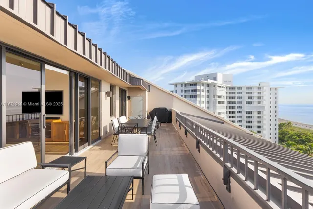 a view of balcony with couch and chairs