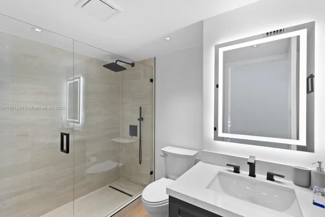 a bathroom with a sink toilet and shower