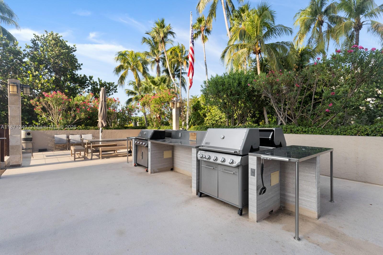 251 Crandon Boulevard, Unit 1036 Key Biscayne, FL 33149 - Photo 27 of 38 a view of a patio with chairs and potted plants