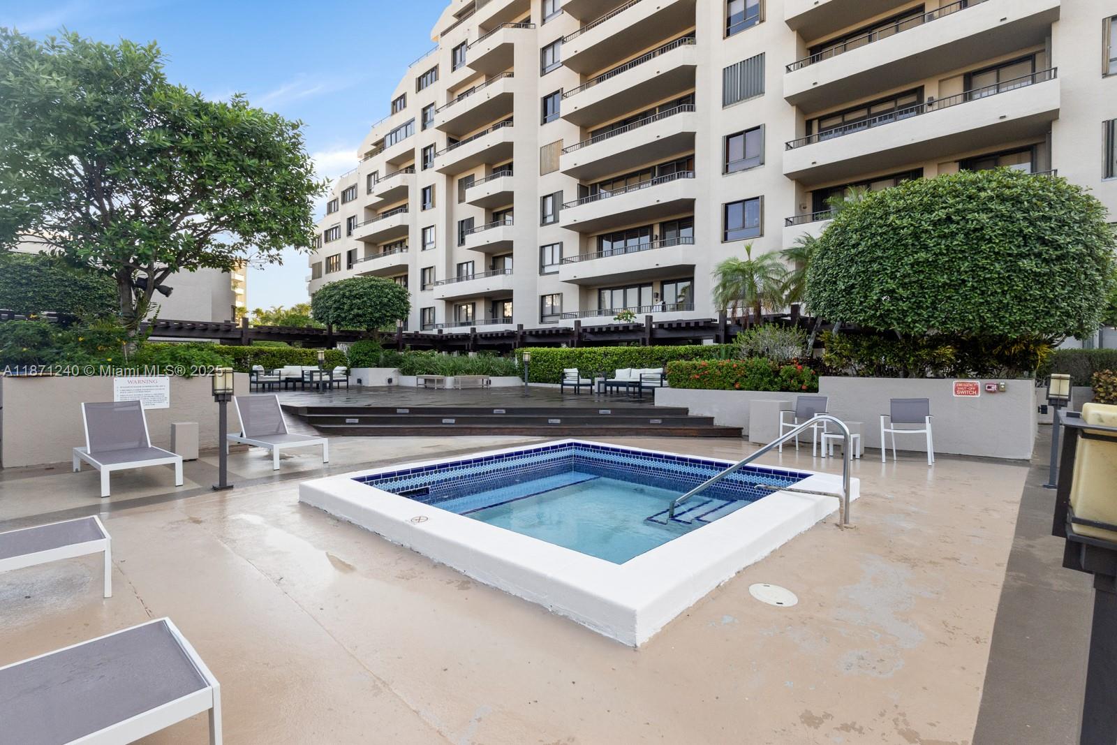 251 Crandon Boulevard, Unit 1036 Key Biscayne, FL 33149 - Photo 29 of 38 a view of a swimming pool with a lounge chair