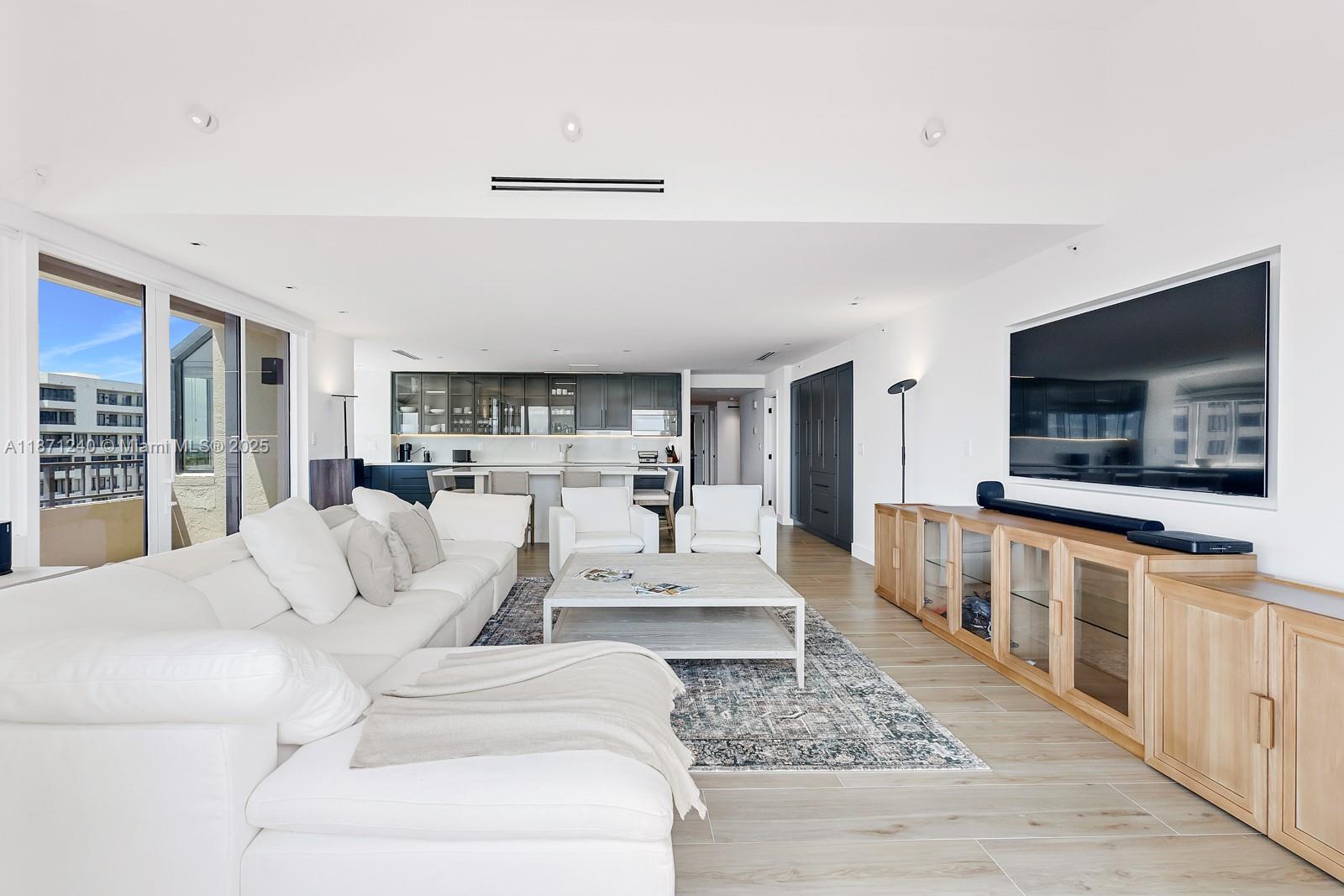 251 Crandon Boulevard, Unit 1036 Key Biscayne, FL 33149 - Photo 3 of 38 a living room with furniture and a flat screen tv