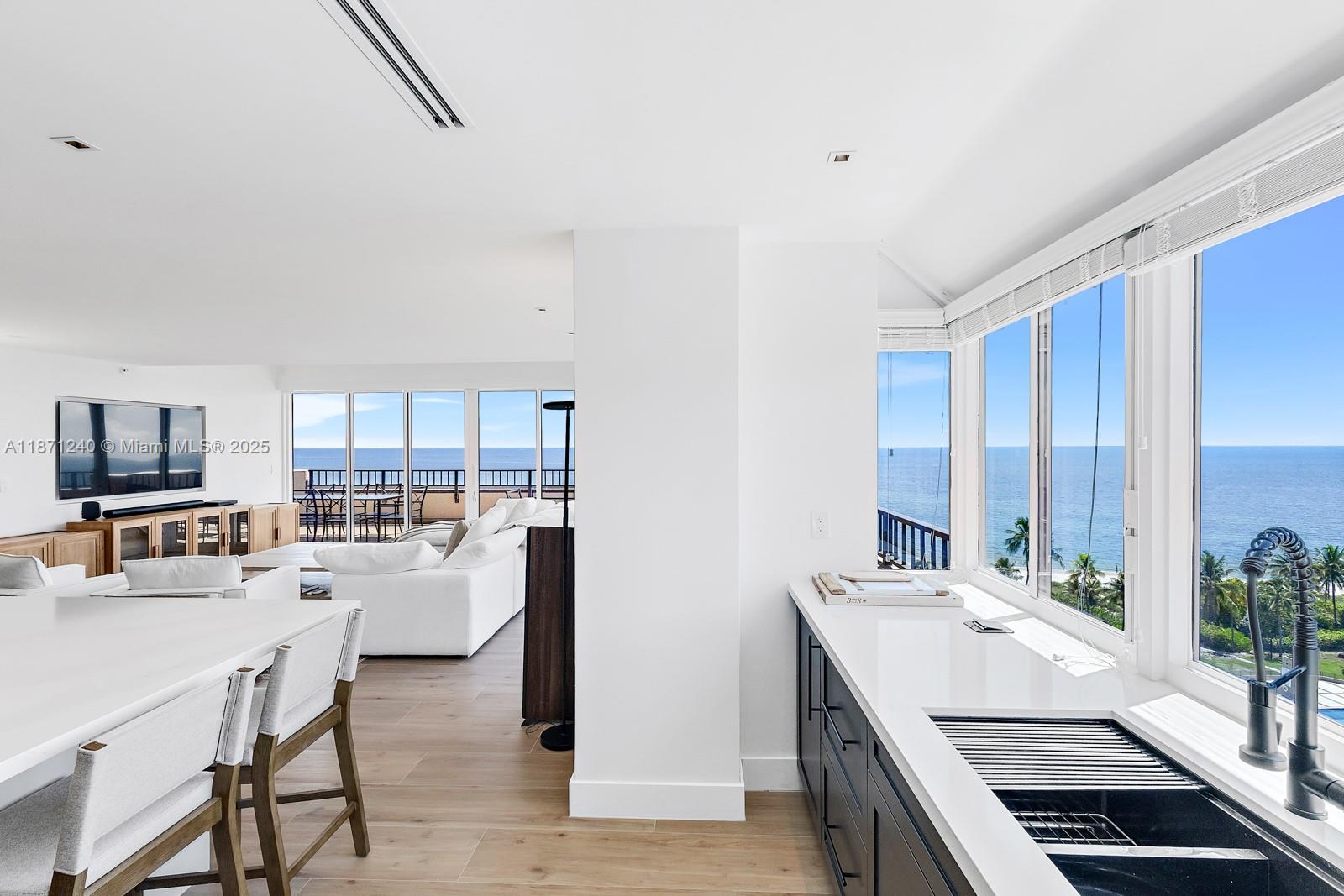 251 Crandon Boulevard, Unit 1036 Key Biscayne, FL 33149 - Photo 4 of 38 a kitchen with stainless steel appliances kitchen island granite countertop a sink and cabinets