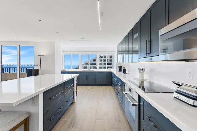a kitchen with counter top space sink and stainless steel appliances