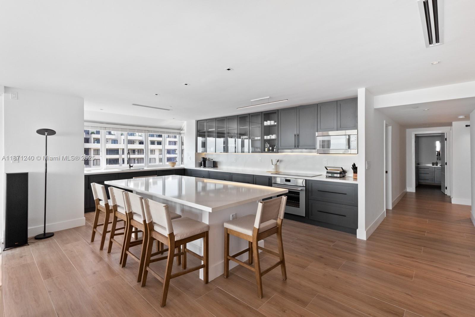 251 Crandon Boulevard, Unit 1036 Key Biscayne, FL 33149 - Photo 6 of 38 a dining room with furniture and wooden floor