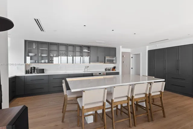 a kitchen with a table and chairs in it