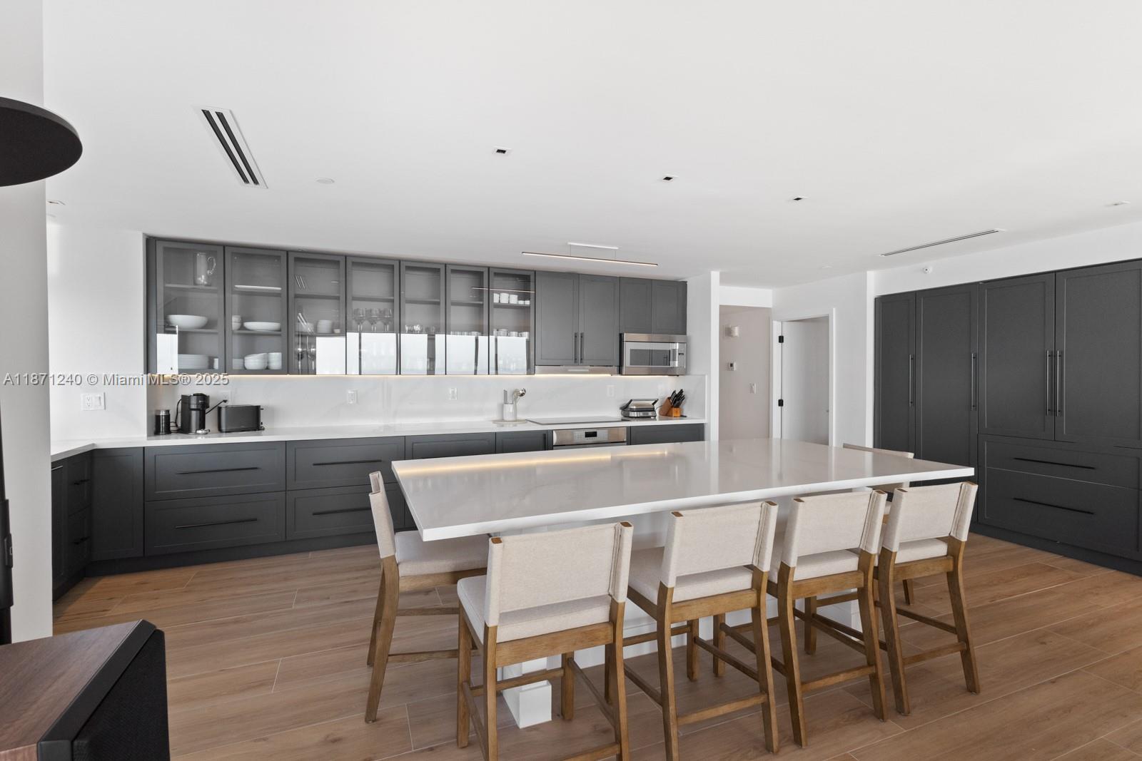 251 Crandon Boulevard, Unit 1036 Key Biscayne, FL 33149 - Photo 7 of 38 a kitchen with a table and chairs in it