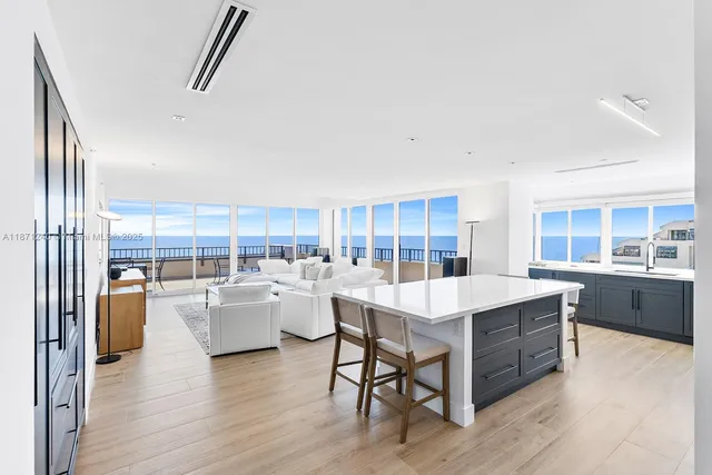 a large white kitchen with a large window