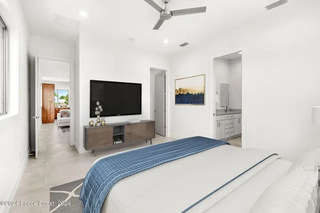 a bedroom with a bed and a flat screen tv