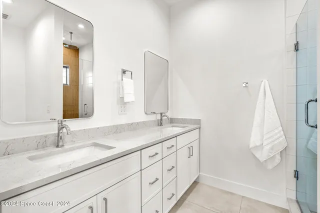 a bathroom with a double vanity sink and a mirror