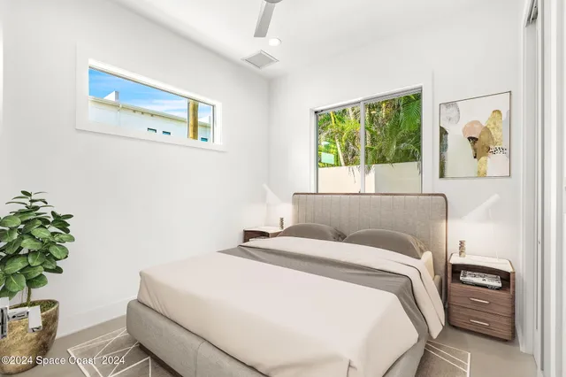 a bedroom with a bed and a painting on the wall