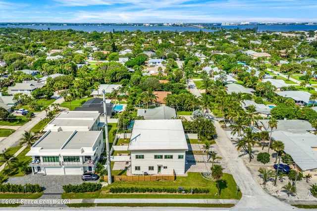 an aerial view of a large building and trees