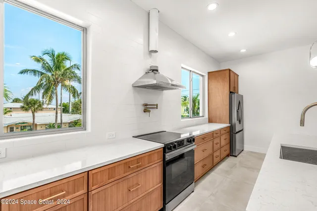 a kitchen with stainless steel appliances granite countertop a sink and a stove