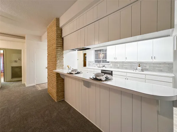 a kitchen with stainless steel appliances a sink stove and cabinets