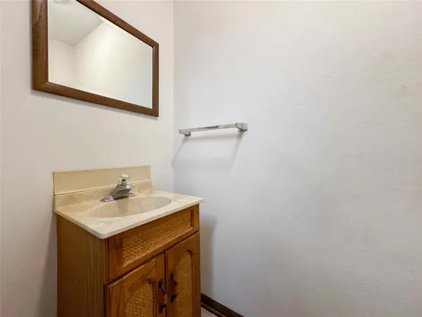 a bathroom with a sink mirror and vanity