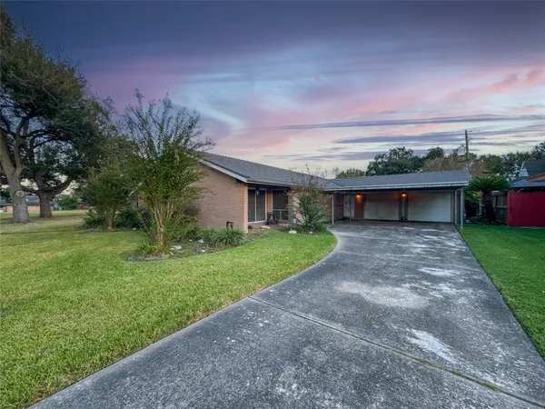 a front view of a house with a yard and a garage