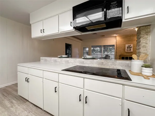 a kitchen with stainless steel appliances granite countertop a sink a stove and cabinets