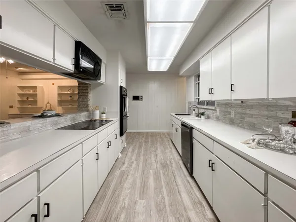 a view of a kitchen with electric appliances