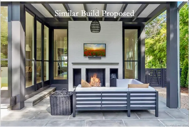 a view of a couches and dinning room with a fireplace