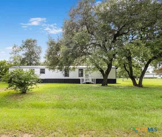 a view of a house with a big yard