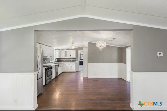 a view of a kitchen with a sink and a refrigerator