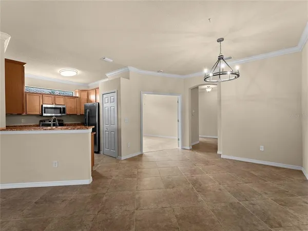 a view of a kitchen with refrigerator and cabinets