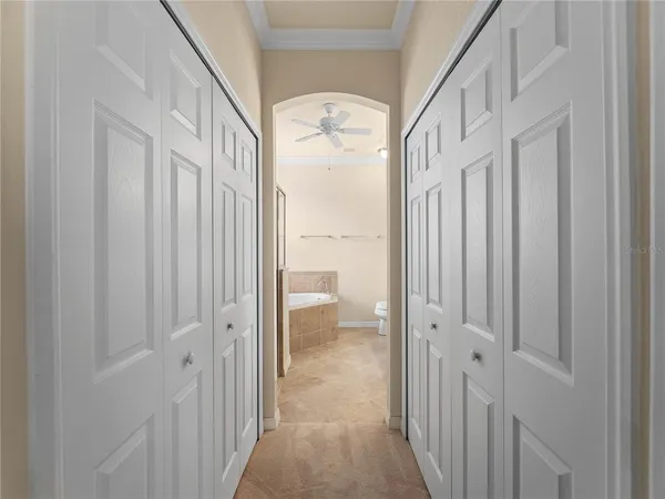 a view of a hallway with wooden floor and entryway