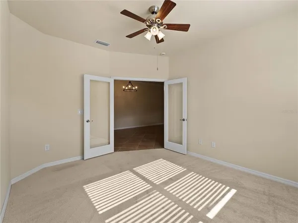 a bedroom with a bed and a ceiling fan