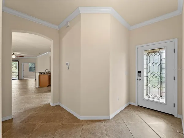 a view of a hallway with wooden floor and a bathroom