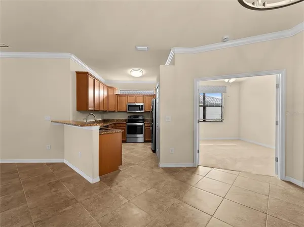 a view of kitchen with stove and cabinets