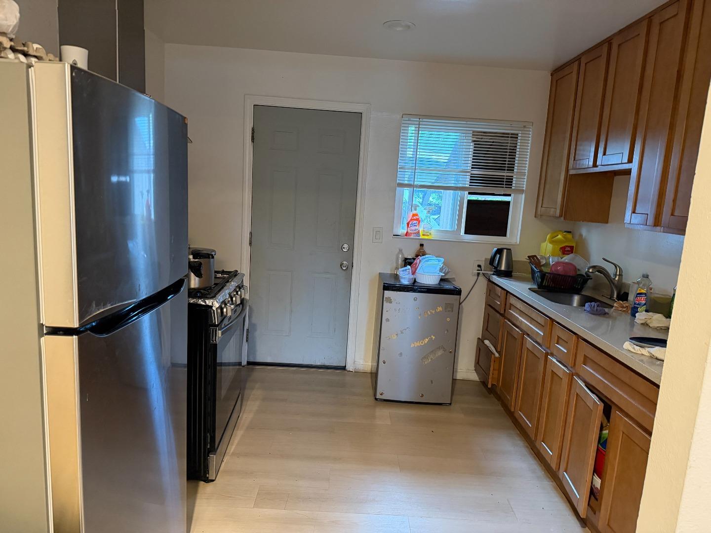 1704 Dutton Avenue Santa Rosa, CA 95407 - Photo 2 of 10 a kitchen with a refrigerator and a sink