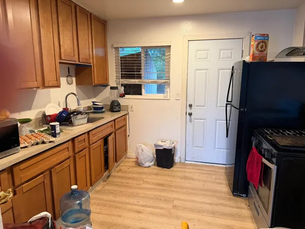 a kitchen with stainless steel appliances a refrigerator stove and sink