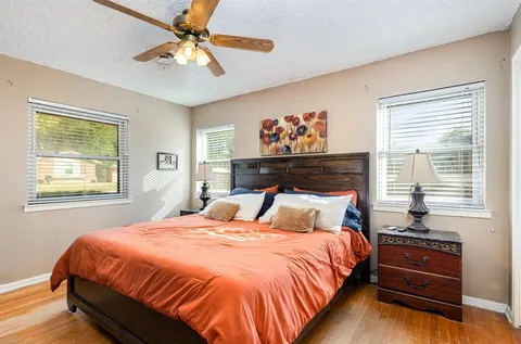 a bedroom with a bed and a painting on the wall