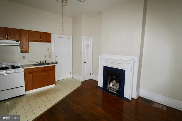 a open kitchen with granite countertop a stove top oven