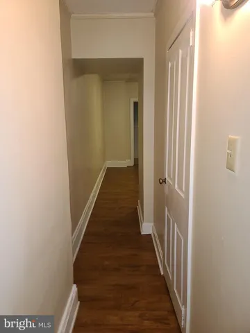 a view of a hallway with a wooden floor