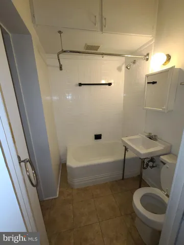 a bathroom with a sink a toilet and bathtub
