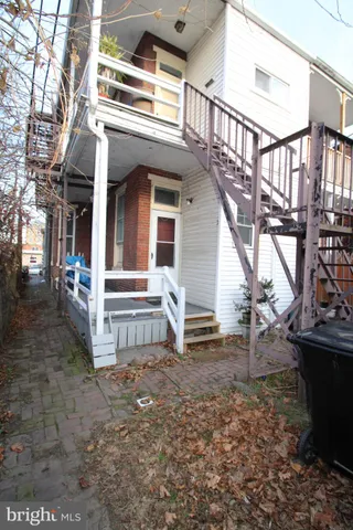 a view of house with deck and outdoor seating