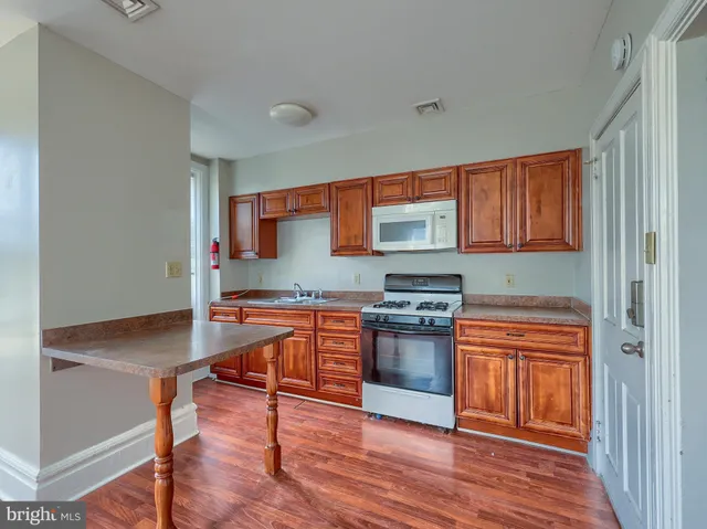 a room with wooden floor and chandelier