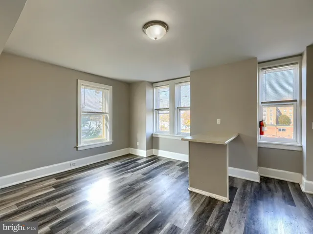 a kitchen with wooden floors and white appliances