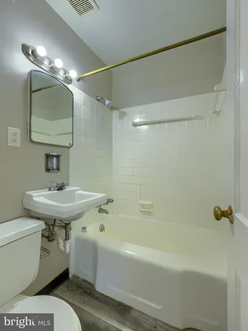 a bathroom with a sink a mirror and a bathtub