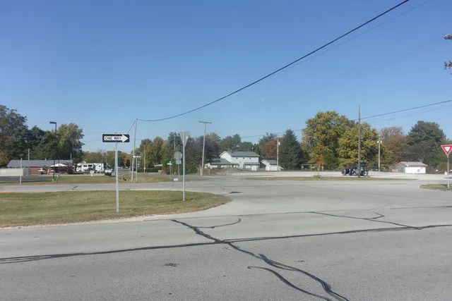 a view of a house with a big yard and a large tree